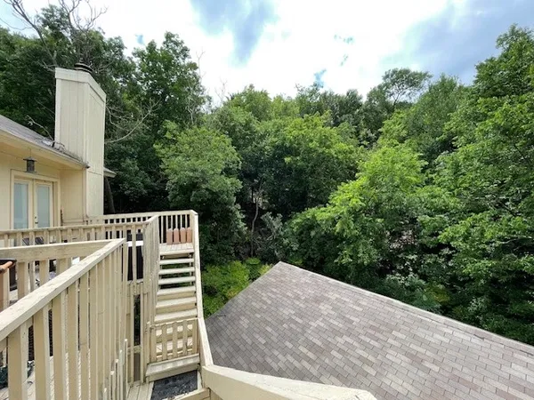 a view of a wooden deck and a backyard