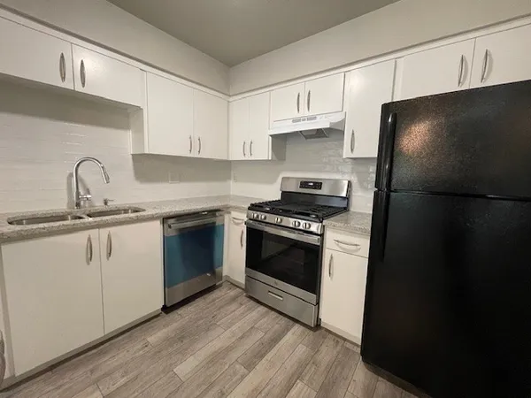a kitchen with a sink stove and refrigerator