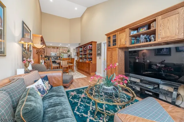 a living room with furniture kitchen view and a dining table
