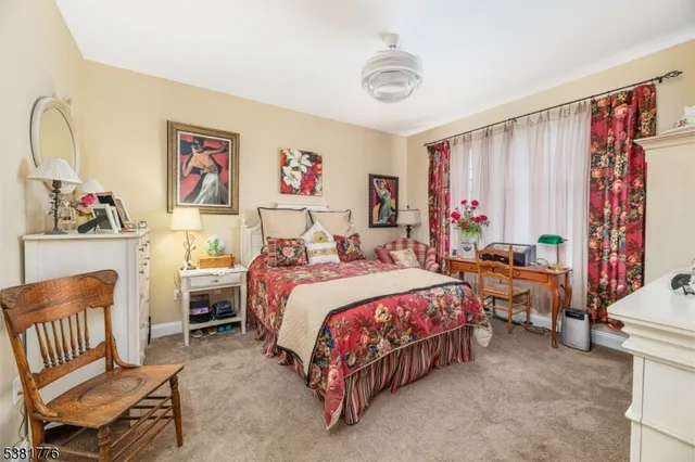 a bedroom with bed and a chandelier