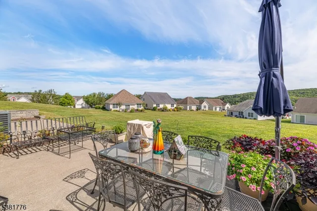 a view of a house with a yard and sitting area