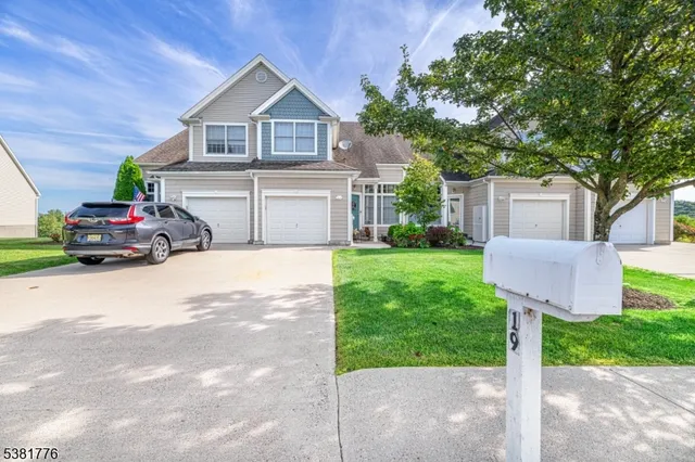 a potted plant sitting in front of a house with potted plants