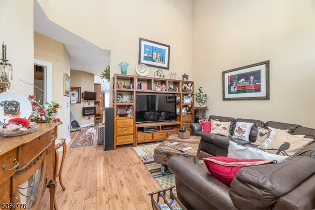 a living room with furniture and a book shelf