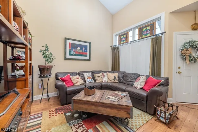 a living room with furniture and flowers