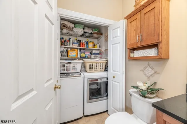 a kitchen with stainless steel appliances kitchen island granite countertop a stove top oven a sink a dining table and chairs with wooden floor