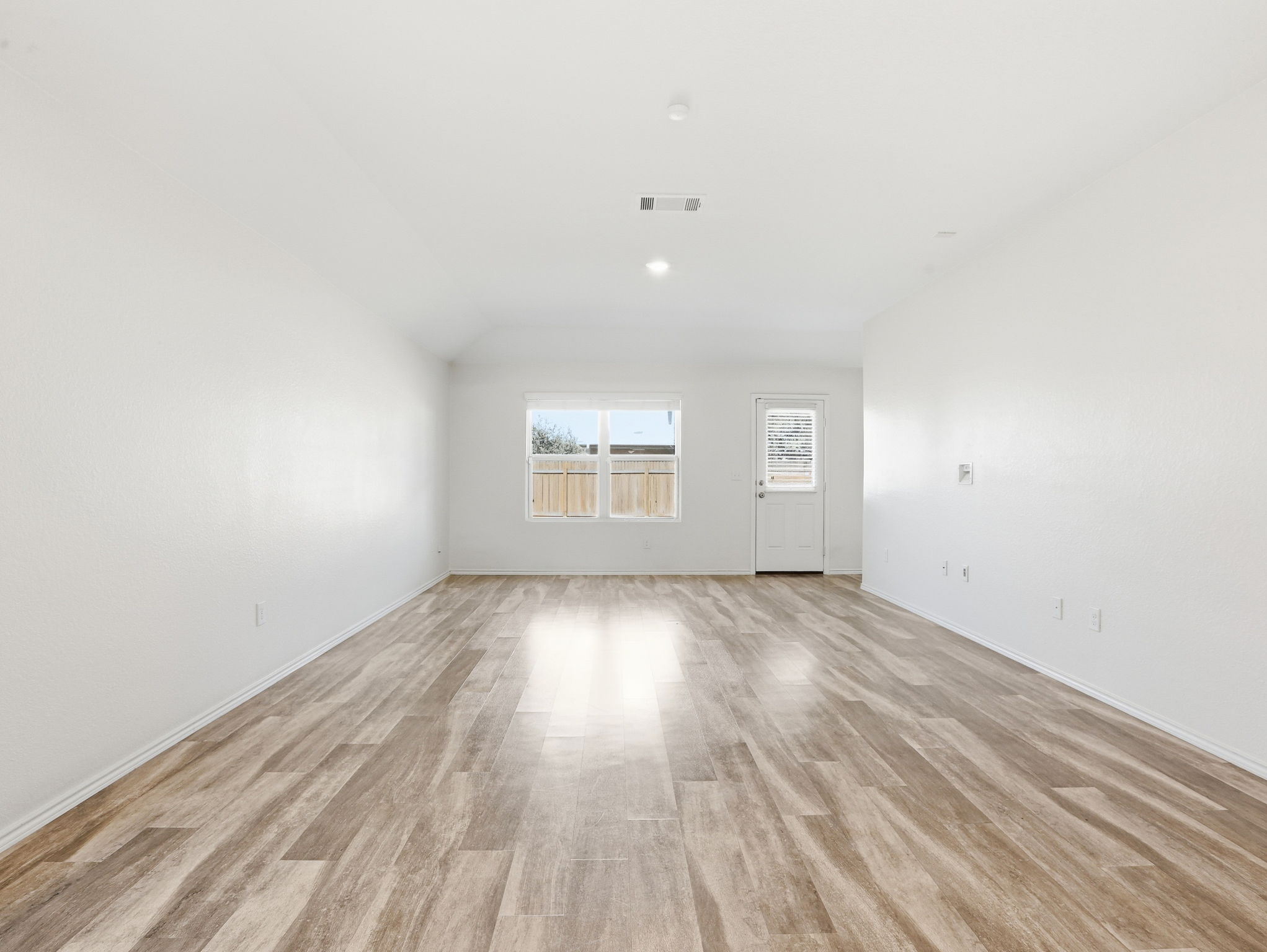 5900 Bell Tower Lane Austin, TX 78747 - Photo 14 of 26 Spare room featuring light wood-style floors and lofted ceiling
