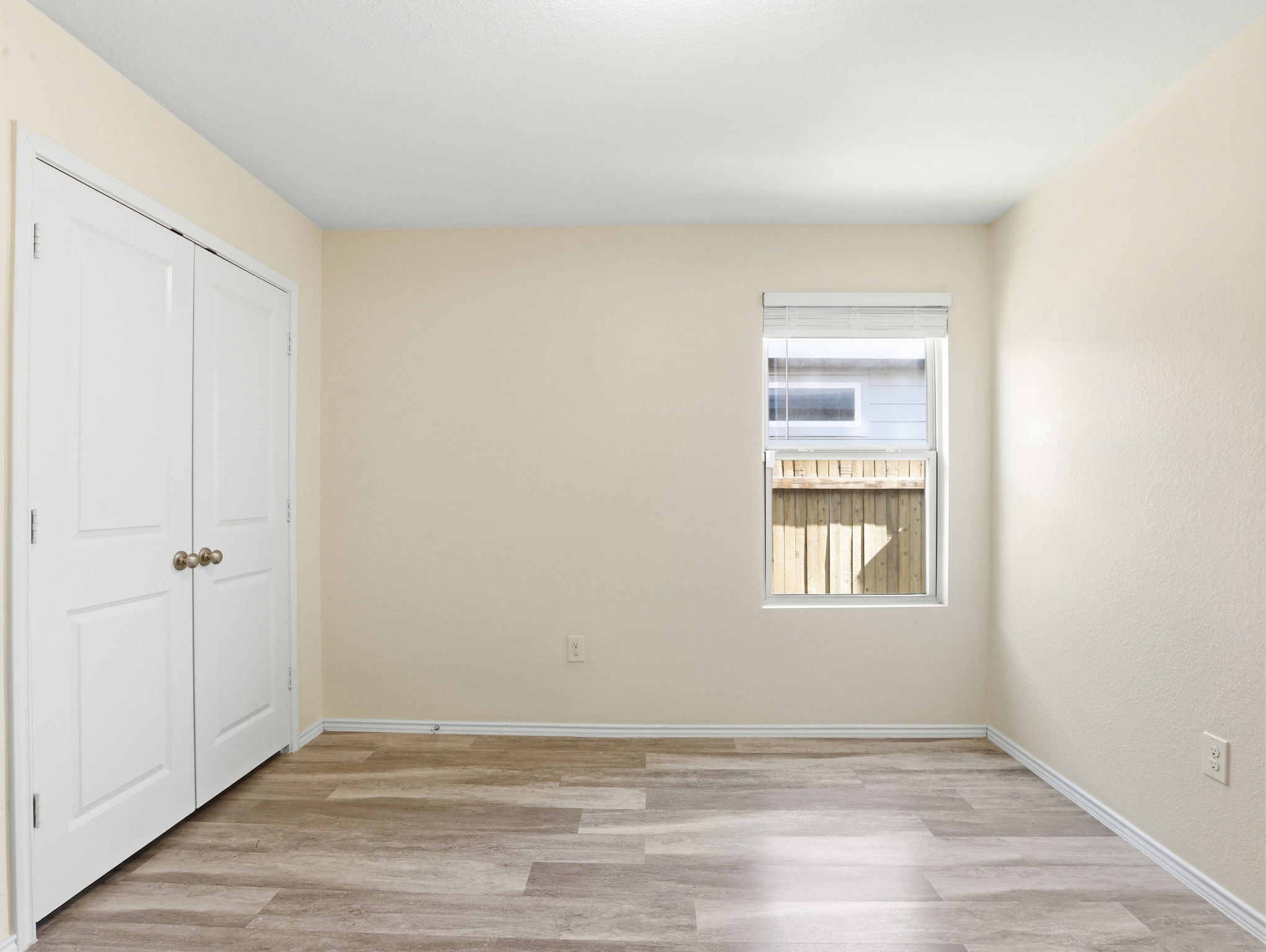 5900 Bell Tower Lane Austin, TX 78747 - Photo 15 of 26 Unfurnished bedroom featuring light wood-style flooring and a closet