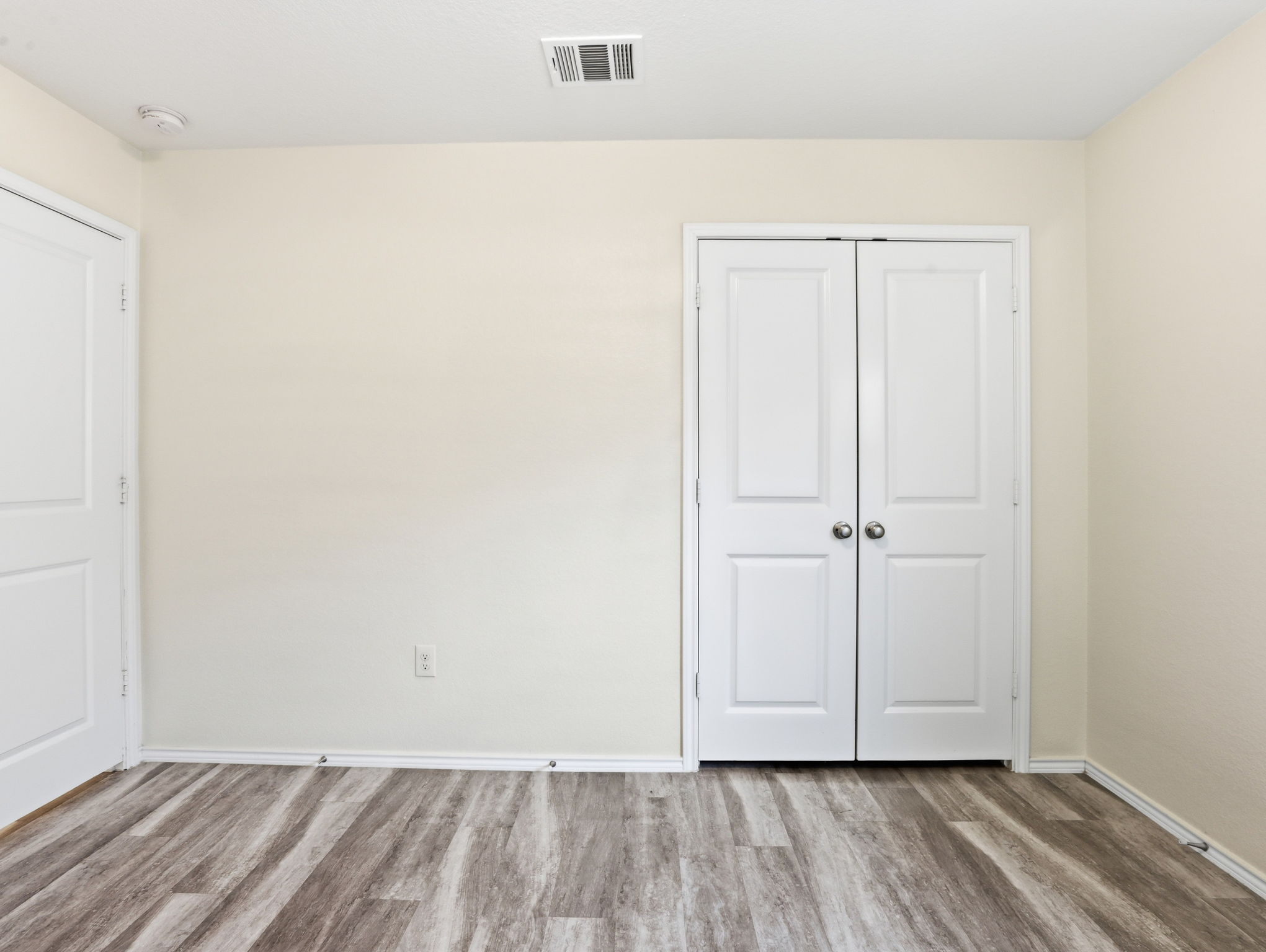 5900 Bell Tower Lane Austin, TX 78747 - Photo 16 of 26 Unfurnished bedroom featuring light wood-style flooring and a closet