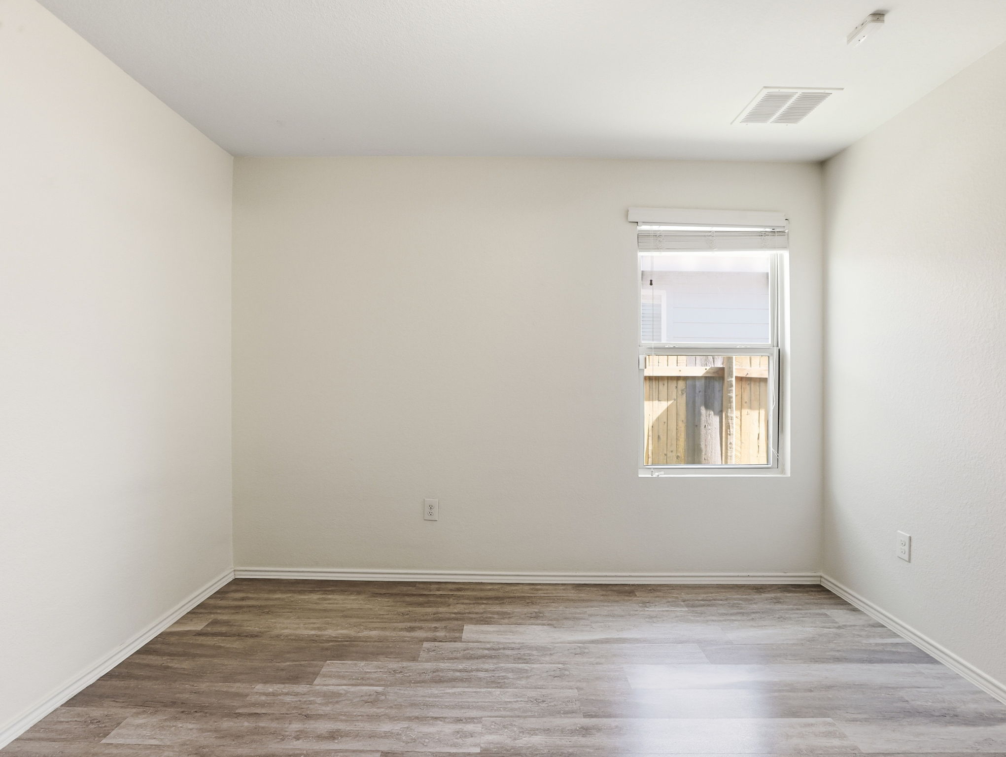 5900 Bell Tower Lane Austin, TX 78747 - Photo 17 of 26 Unfurnished room featuring light wood-type flooring and baseboards