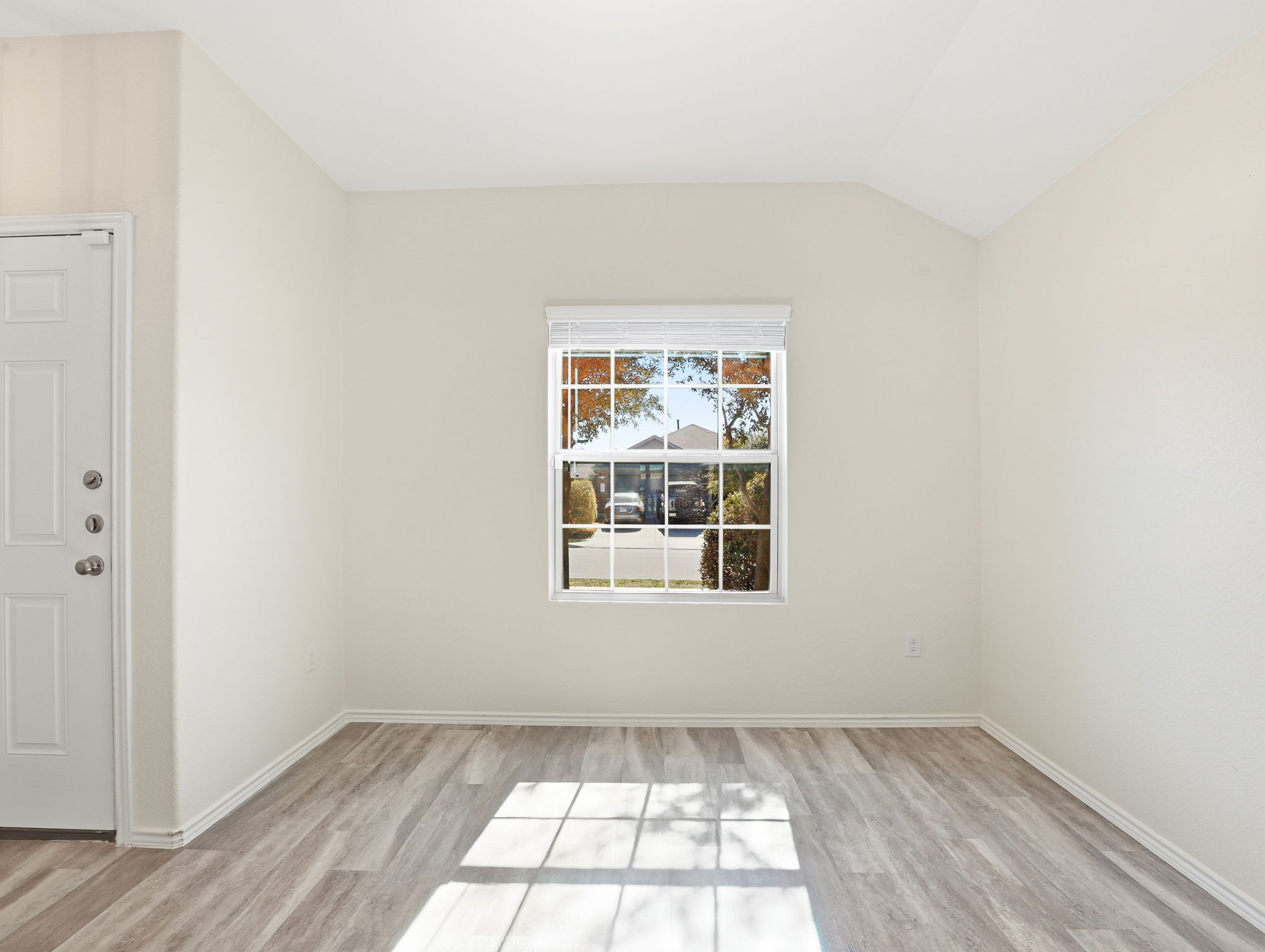 5900 Bell Tower Lane Austin, TX 78747 - Photo 19 of 26 Empty room featuring light wood-style floors and vaulted ceiling