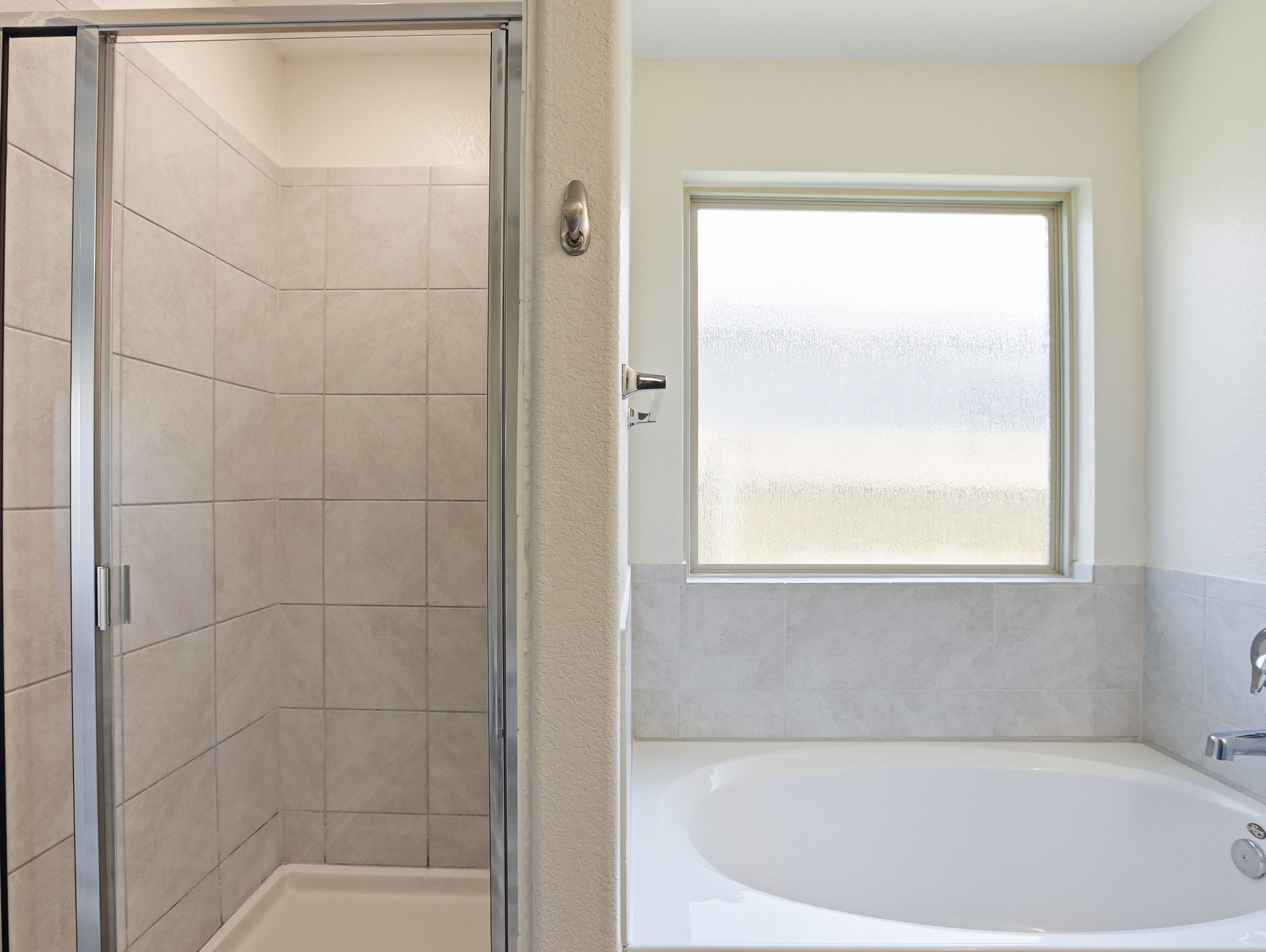 5900 Bell Tower Lane Austin, TX 78747 - Photo 9 of 26 Bathroom with a stall shower, healthy amount of natural light, and a bath