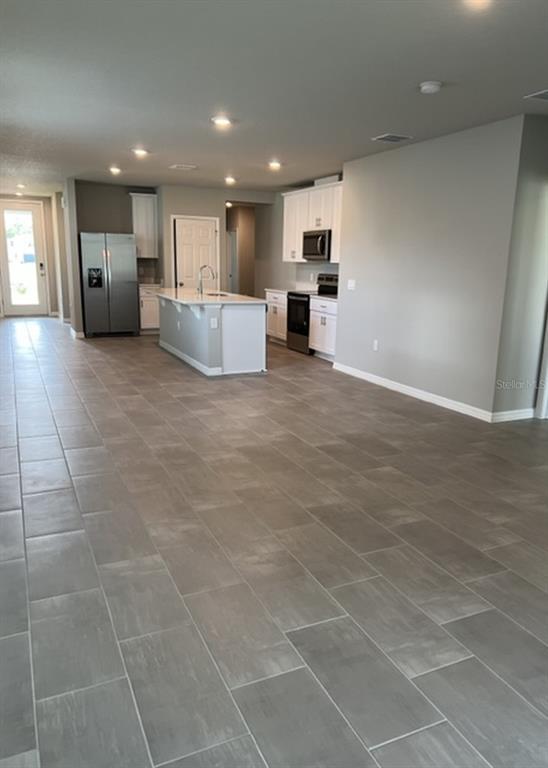 953 Rivers Crossing Street Clermont, FL 34714 - Photo 5 of 22 a view of empty room with kitchen