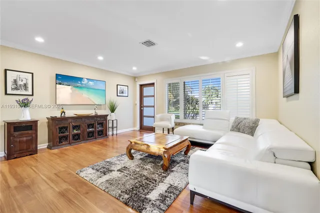 a living room with furniture and large flat screen tv