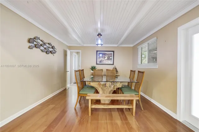 a view of a dining room with furniture wooden floor and chandelier