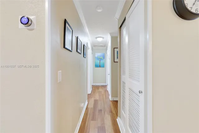 a view of a hallway with wooden floor