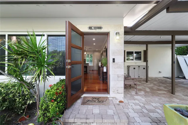 a view of a hallway with potted plants