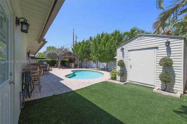 a view of a backyard with plants and a patio