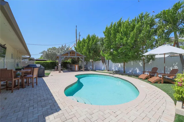 an outdoor space with swimming pool and furniture