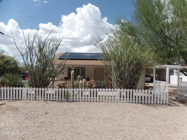 a front view of a house with wooden fence