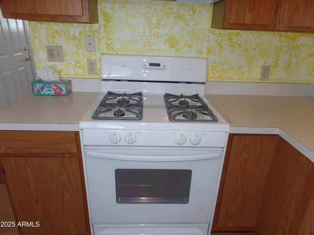 a stove top oven sitting inside of a kitchen