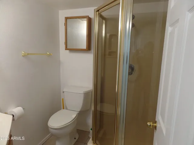 a white toilet sitting next to a bathroom sink