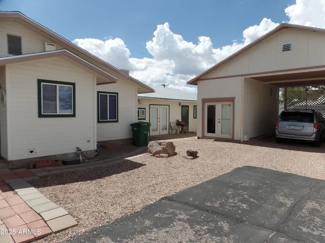 a view of a house with backyard space and sitting area