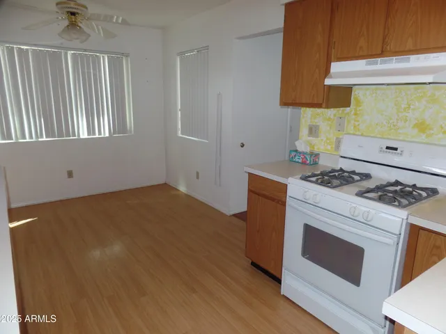 a kitchen with a stove and a refrigerator