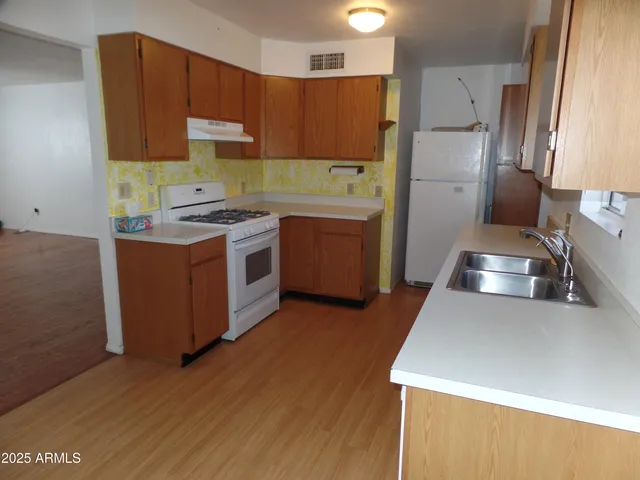 a kitchen with a refrigerator sink and stove