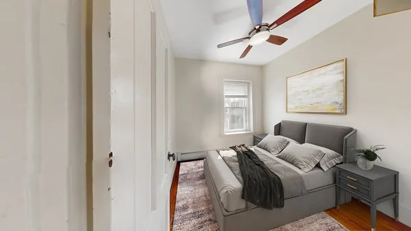 a bedroom with a bed dresser and a window