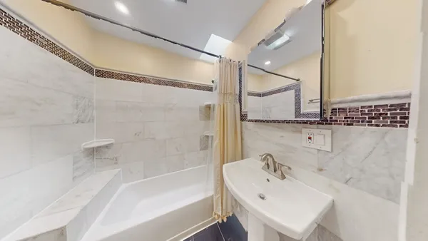 a bathroom with a bathtub and a sink