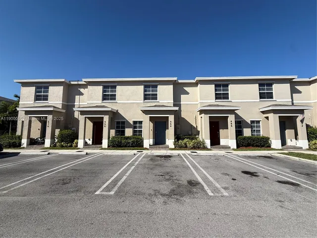 a front view of a building with a yard