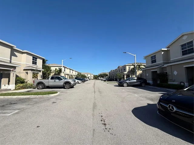 a view of street with parked cars