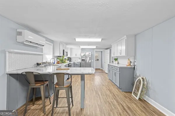 a kitchen with a table and chairs in it