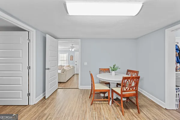 a dining room with furniture and wooden floor