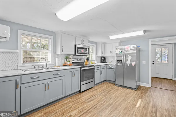 a kitchen with white cabinets and white appliances