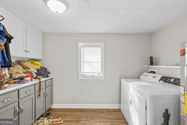 a utility room with cabinets washer and dryer