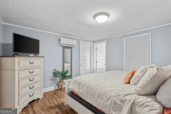 a bedroom with a bed and a flat screen tv