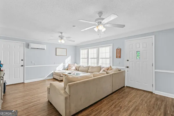 a living room with furniture and a chandelier