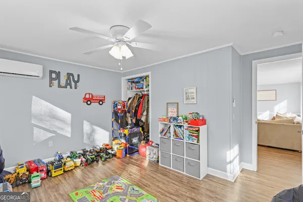 a view of a livingroom with an entryway and wooden floor