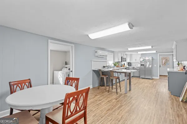 a dining room with furniture and wooden floor