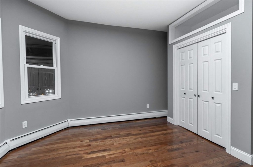 522 Broadway Fall River, MA 02724 - Photo 11 of 15 a view of an empty room with wooden floor and a window