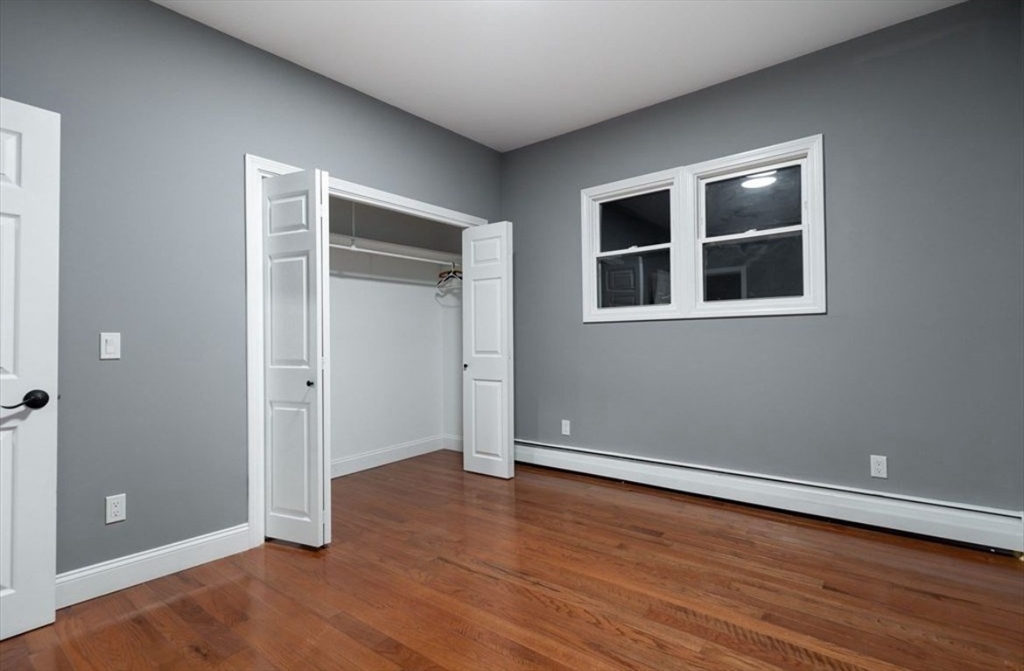 522 Broadway Fall River, MA 02724 - Photo 12 of 15 an empty room with wooden floor and windows