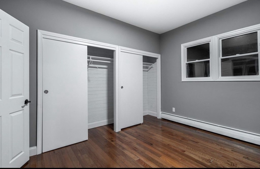 522 Broadway Fall River, MA 02724 - Photo 15 of 15 an empty room with wooden floor and closet