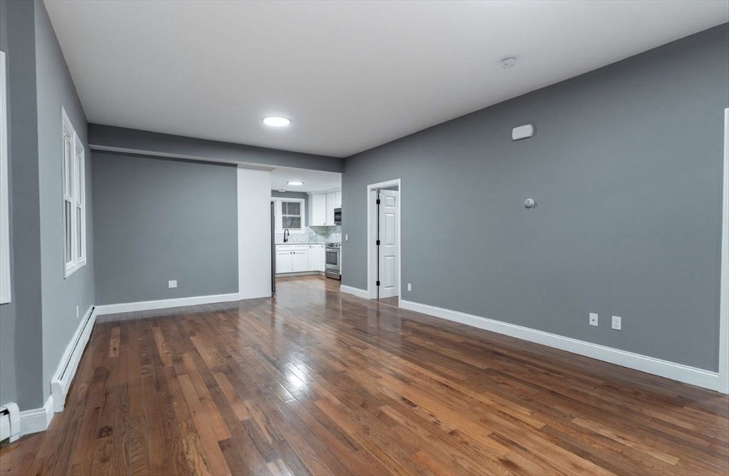 522 Broadway Fall River, MA 02724 - Photo 7 of 15 a view of an empty room with wooden floor