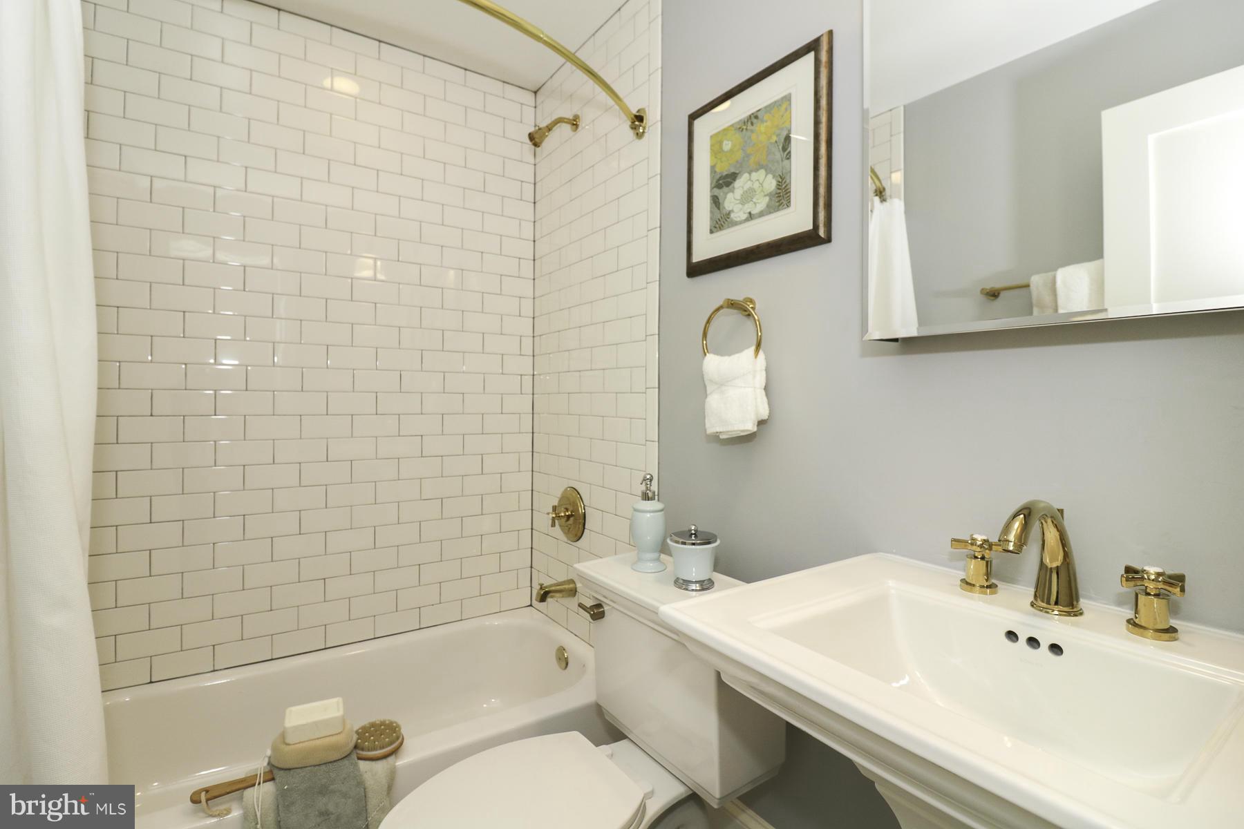 124 11th Street Northeast Washington, DC 20002 - Photo 27 of 30 a bathroom with a sink mirror toilet and bathtub