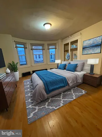 a bedroom with a large bed and a couch