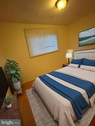 a bedroom with a bed and a lamp with potted plant