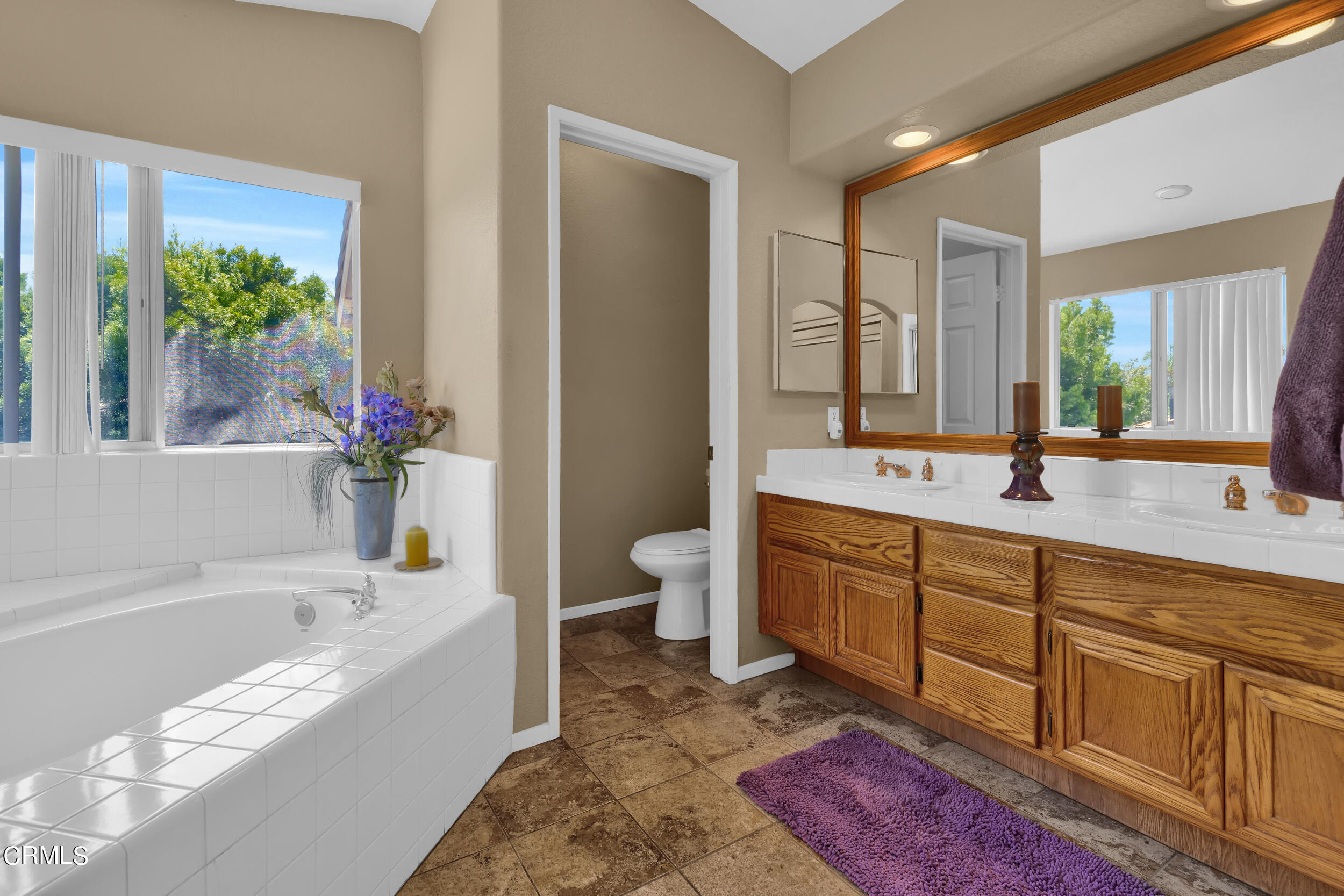 20182 Hill Spring Road Wildomar, CA 92595 - Photo 22 of 47 a spacious bathroom with a tub sink and mirror