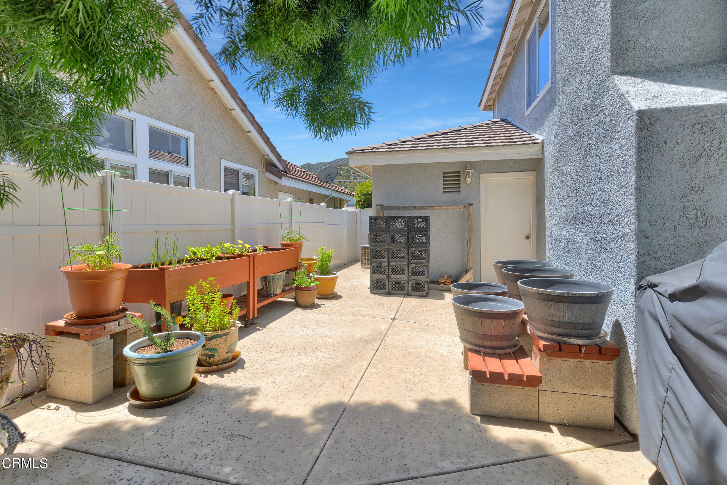 20182 Hill Spring Road Wildomar, CA 92595 - Photo 34 of 47 a group of potted plants sitting in front of a house