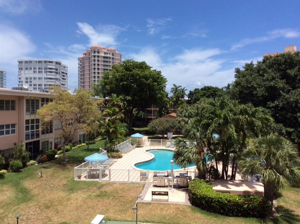 1481 South Ocean Boulevard, Unit 416A Lauderdale-by-the-Sea, FL 33062 - Photo 15 of 16 a view of a patio with a table and chairs and potted plants